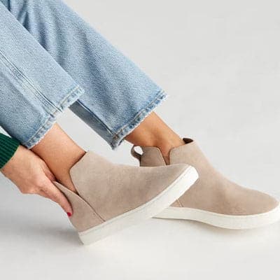 Taupe suede ankle boots worn with cropped jeans